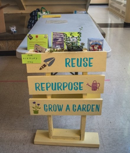 A decorated sign showing to "Reuse Repurpose , Grow a Garden"